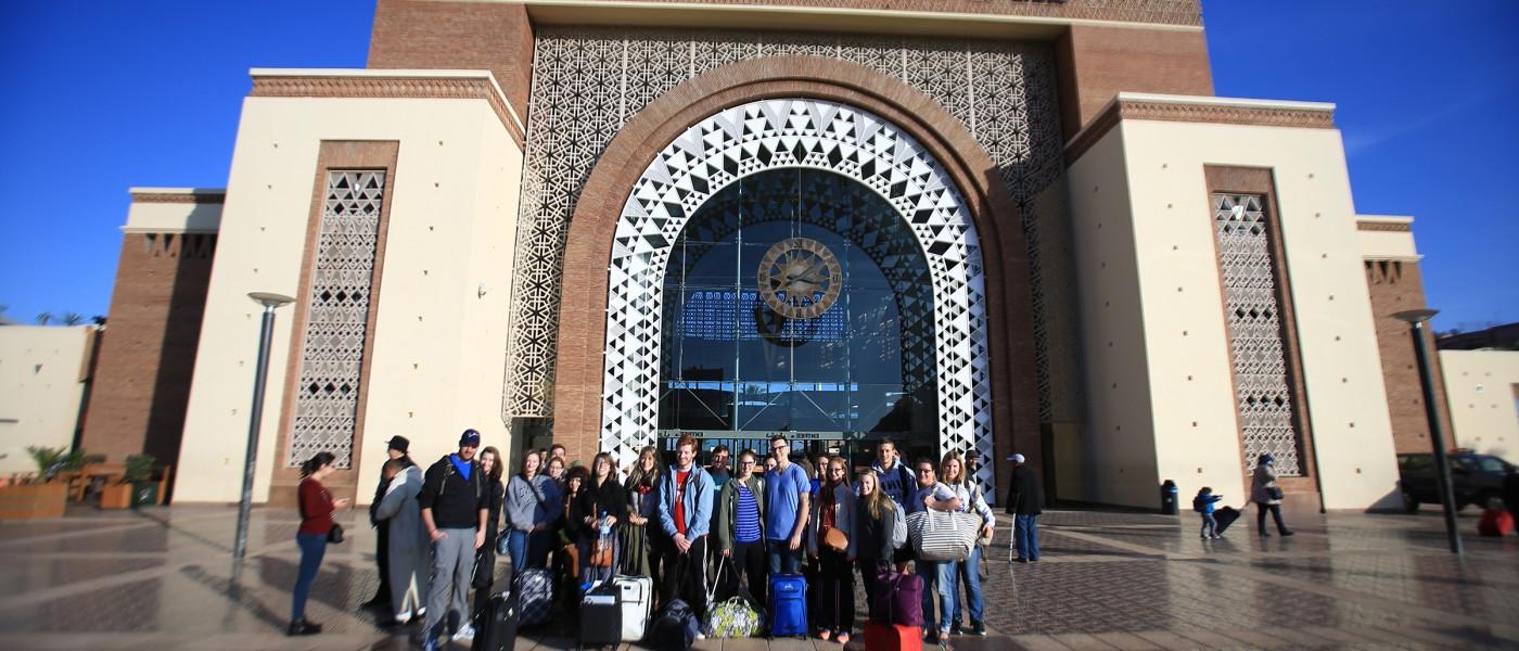 学生 arrive at the Marrakesh train station during a group excursion.